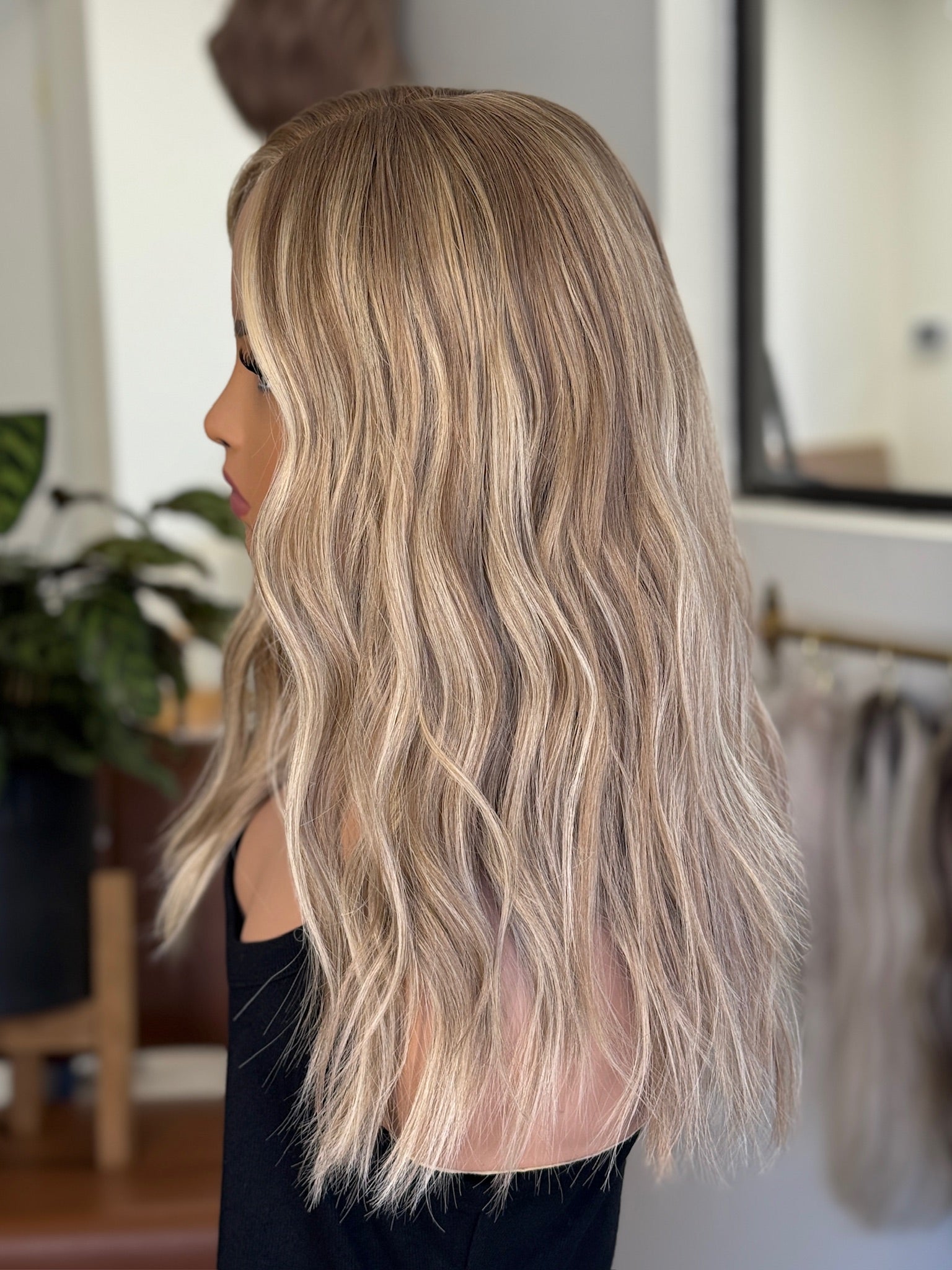 Blonde wig with long, wavy blonde hair .
